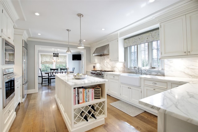 52 Northwoods Rd, Manhasset, NY 11030 - kitchen with wall chimney range hood, stainless steel appliances, a sink, open shelves, and tasteful backsplash
