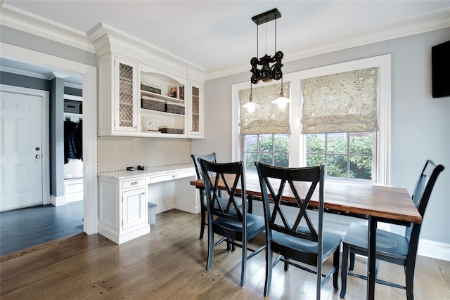52 Northwoods Rd, Manhasset, NY 11030 - dining space with dark wood-style flooring, ornamental molding, and baseboards