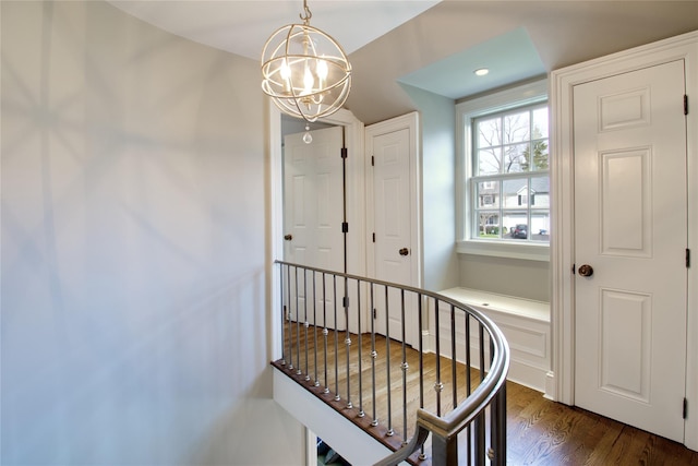 52 Northwoods Rd, Manhasset, NY 11030 - hallway with dark wood finished floors and a chandelier