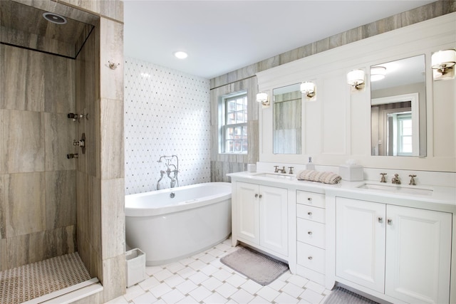 52 Northwoods Rd, Manhasset, NY 11030 - full bath featuring double vanity, a freestanding bath, plenty of natural light, a tile shower, and wallpapered walls
