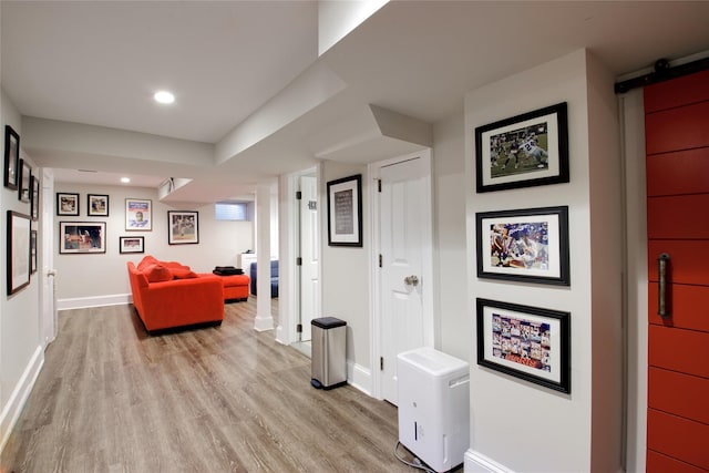 52 Northwoods Rd, Manhasset, NY 11030 - hallway featuring light wood-type flooring, baseboards, a barn door, and recessed lighting