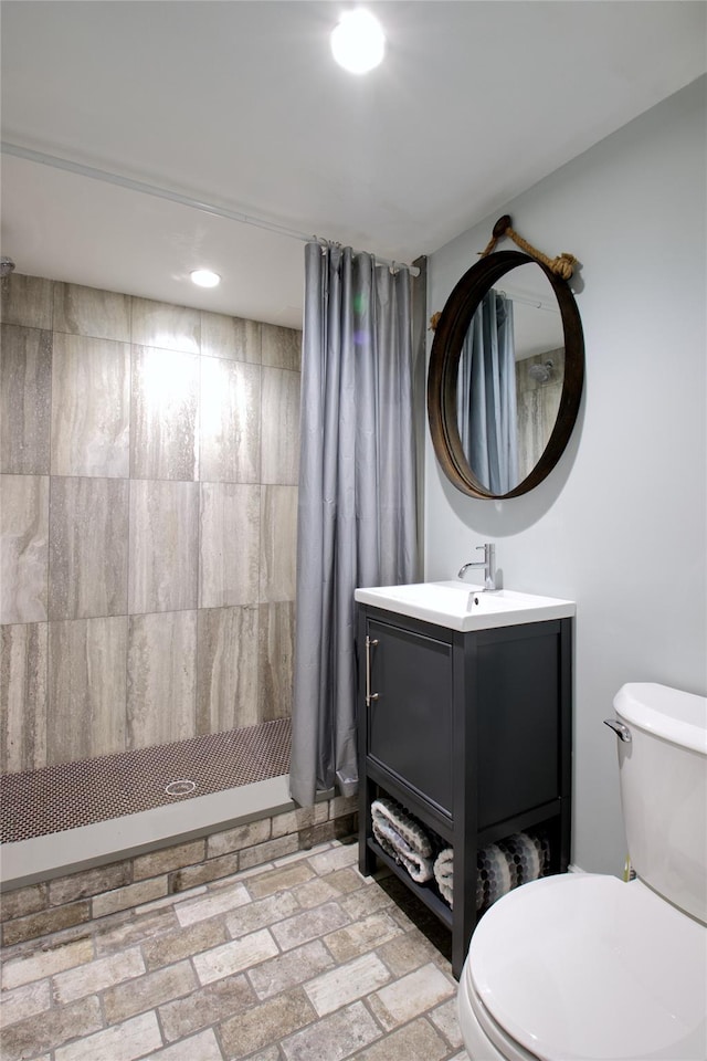 52 Northwoods Rd, Manhasset, NY 11030 - full bath featuring a stall shower, vanity, toilet, brick patterned floors, and recessed lighting