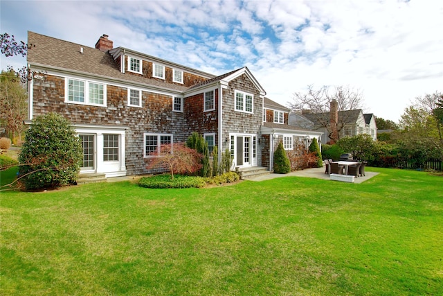 52 Northwoods Rd, Manhasset, NY 11030 - rear view of property with a chimney, a lawn, a patio, roof with shingles, and entry steps