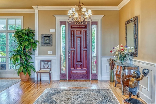 1640 Grandview Dr, Orient, NY 11957 - foyer with a chandelier, plenty of natural light, crown molding, wood finished floors, and a decorative wall