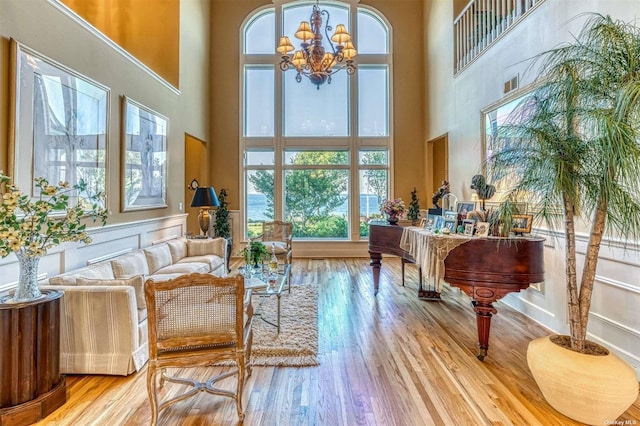1640 Grandview Dr, Orient, NY 11957 - sitting room featuring a towering ceiling, wood finished floors, and a chandelier