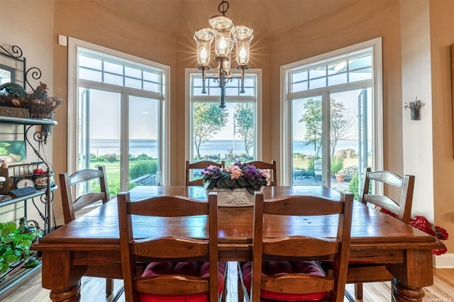 1640 Grandview Dr, Orient, NY 11957 - dining space featuring a chandelier, wood finished floors, and baseboards