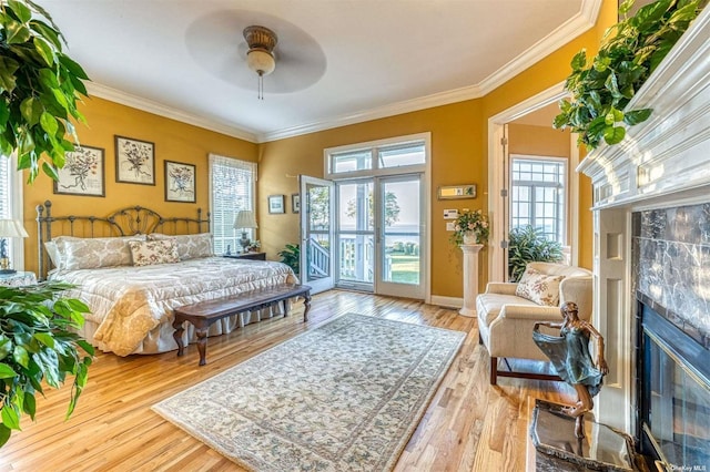 1640 Grandview Dr, Orient, NY 11957 - bedroom featuring a fireplace, hardwood / wood-style flooring, ornamental molding, access to exterior, and baseboards