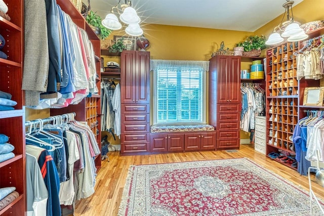 1640 Grandview Dr, Orient, NY 11957 - spacious closet with a chandelier and light wood finished floors
