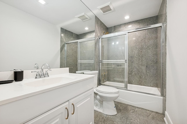 full bathroom featuring visible vents, enclosed tub / shower combo, toilet, and vanity