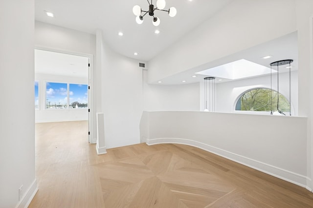 hallway with an inviting chandelier, baseboards, recessed lighting, and visible vents
