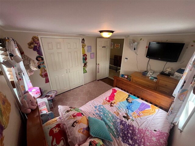 bedroom featuring crown molding and a closet