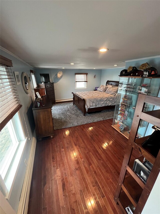 bedroom featuring wood-type flooring, baseboards, and crown molding