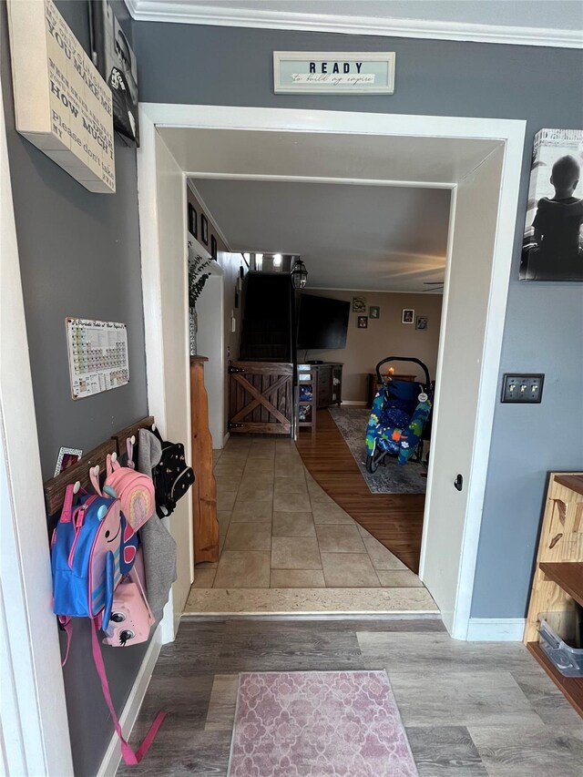 hallway featuring baseboards and wood finished floors
