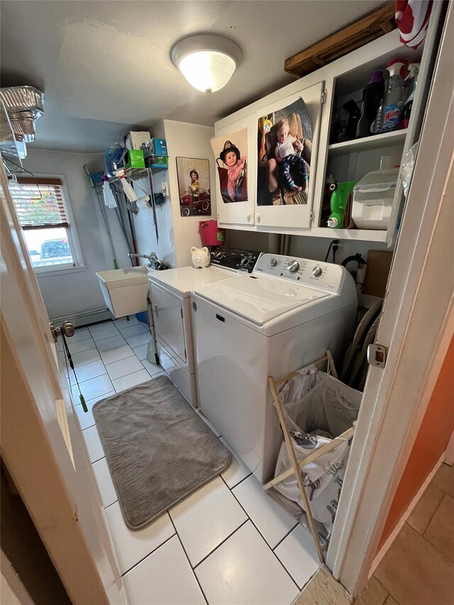laundry room with cabinet space, separate washer and dryer, and light tile patterned floors