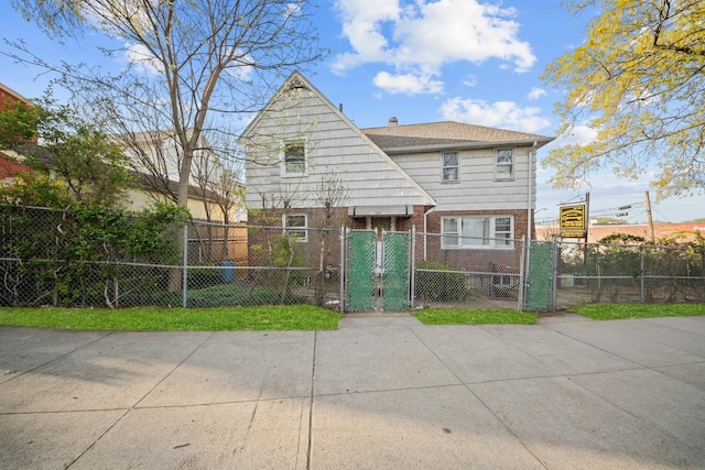 172-11 Horace Hadring Expy, Flushing, NY 11365 - rear view of property featuring a fenced front yard, brick siding, a chimney, and a gate