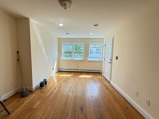 interior space featuring baseboards, recessed lighting, wood finished floors, and baseboard heating