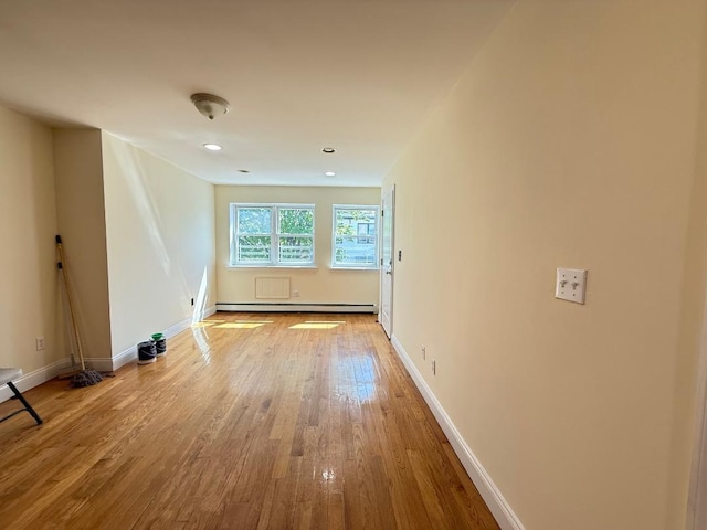 spare room featuring baseboards, recessed lighting, and hardwood / wood-style flooring
