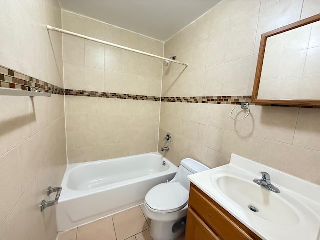 bathroom with tile walls, tile patterned flooring, vanity, toilet, and tub / shower combination