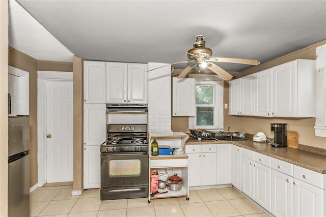 kitchen featuring black gas stove, freestanding refrigerator, a ceiling fan, white cabinetry, and extractor fan