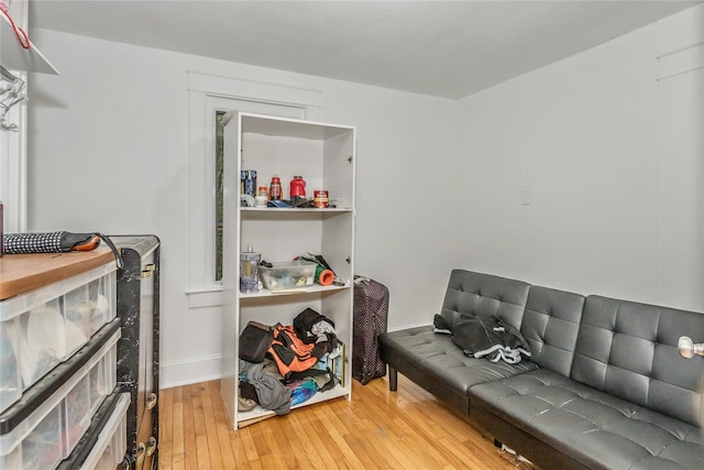 living area with hardwood / wood-style floors and baseboards