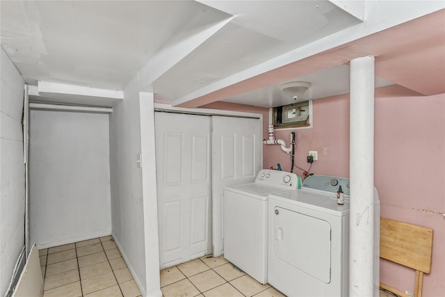 washroom with washer and dryer and light tile patterned floors