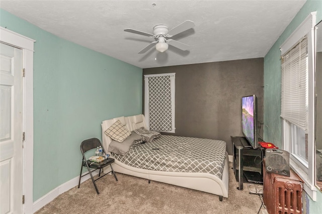 carpeted bedroom with baseboards and ceiling fan