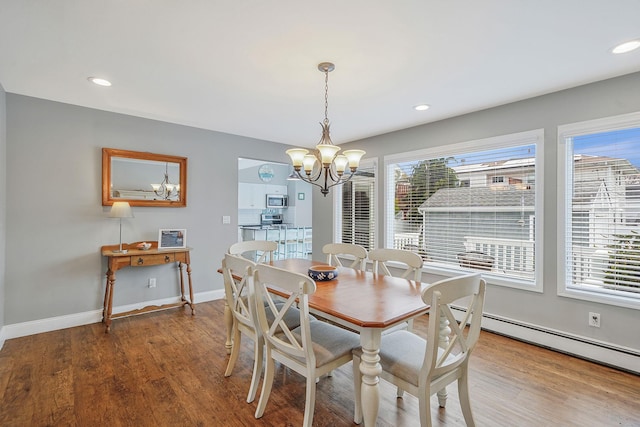 7 Grandview Dr, Shirley, NY 11967 - dining space featuring wood finished floors, a chandelier, and a healthy amount of sunlight