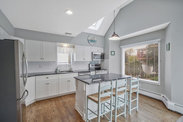 7 Grandview Dr, Shirley, NY 11967 - kitchen featuring visible vents, white cabinets, light wood-style flooring, appliances with stainless steel finishes, and a skylight