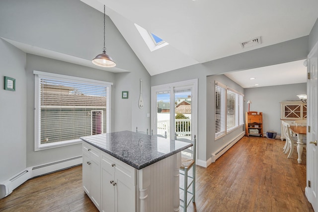 7 Grandview Dr, Shirley, NY 11967 - kitchen featuring a kitchen island, a skylight, wood finished floors, white cabinets, and a baseboard heating unit