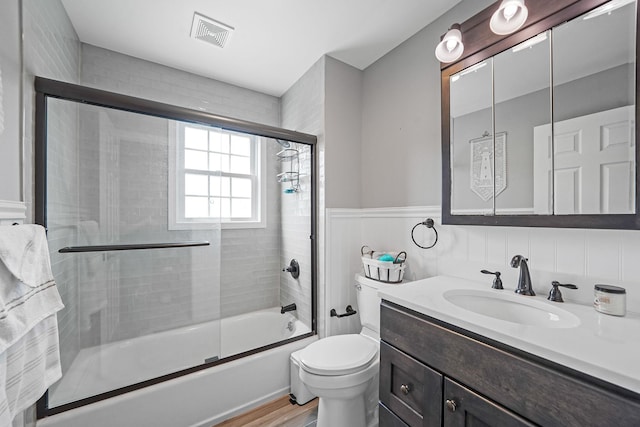 7 Grandview Dr, Shirley, NY 11967 - bathroom featuring visible vents, vanity, wood finished floors, toilet, and combined bath / shower with glass door
