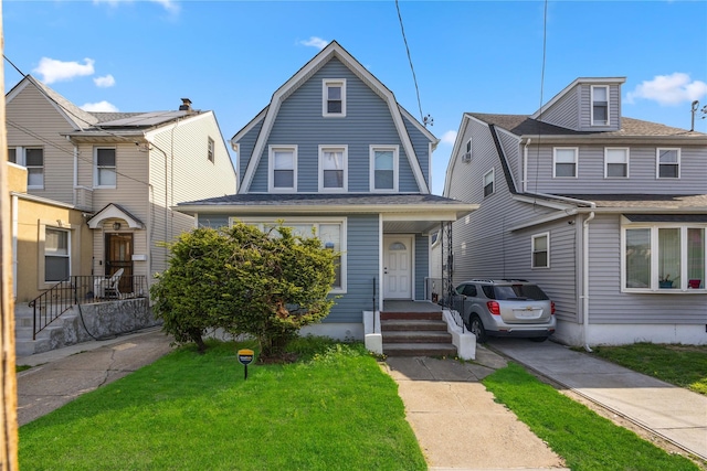 186-09 Dormans Rd, Saint Albans, NY 11412 - dutch colonial featuring a front yard and a gambrel roof