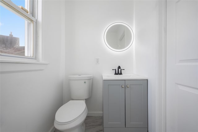 186-09 Dormans Rd, Saint Albans, NY 11412 - half bathroom featuring baseboards, toilet, and vanity