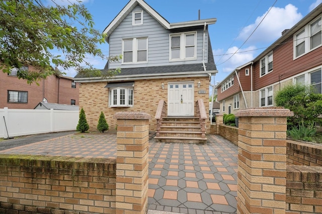 31-50 Buell, East Elmhurst, NY 11369 - view of front of home with entry steps, brick siding, fence, and a patio area
