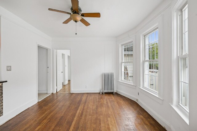 31-50 Buell, East Elmhurst, NY 11369 - spare room with radiator, wood finished floors, baseboards, and ceiling fan