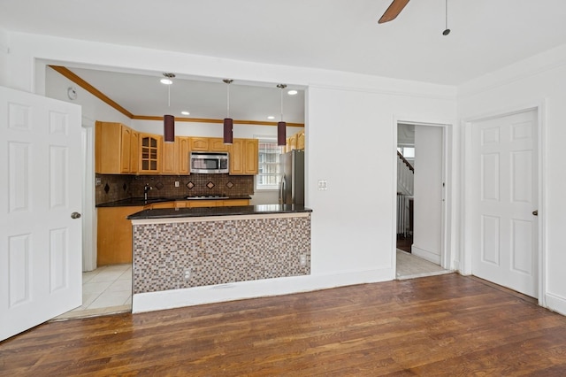 31-50 Buell, East Elmhurst, NY 11369 - kitchen featuring appliances with stainless steel finishes, dark countertops, crown molding, glass insert cabinets, and ceiling fan