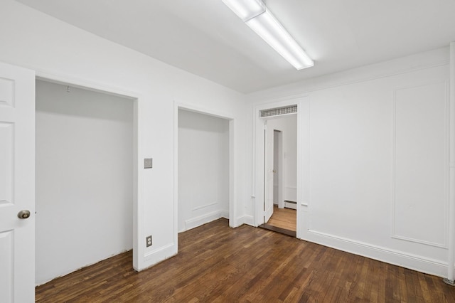 31-50 Buell, East Elmhurst, NY 11369 - below grade area featuring dark wood-style flooring and a baseboard radiator