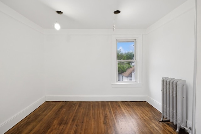 31-50 Buell, East Elmhurst, NY 11369 - empty room featuring radiator, baseboards, and dark wood-type flooring