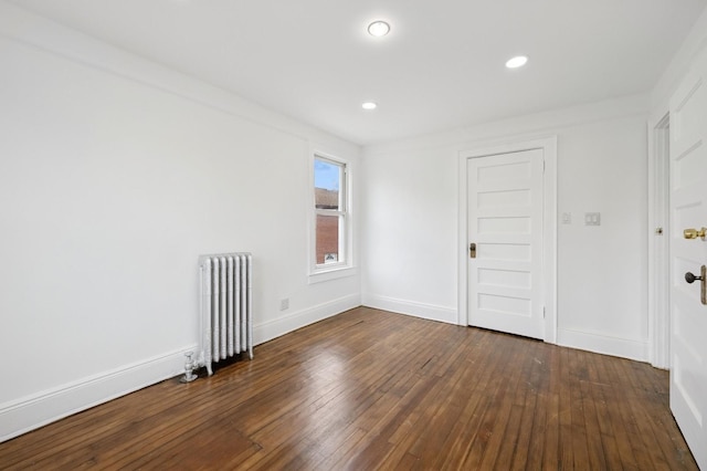 31-50 Buell, East Elmhurst, NY 11369 - empty room with radiator heating unit, wood-type flooring, baseboards, and recessed lighting
