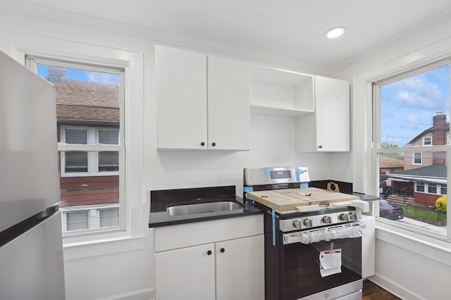 31-50 Buell, East Elmhurst, NY 11369 - kitchen featuring stainless steel appliances, open shelves, white cabinets, dark countertops, and baseboards