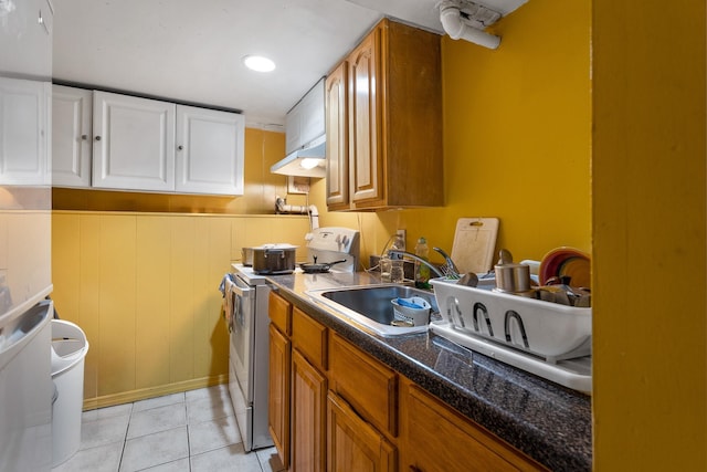 31-50 Buell, East Elmhurst, NY 11369 - kitchen featuring white electric range oven, a sink, light tile patterned floors, under cabinet range hood, and white cabinets