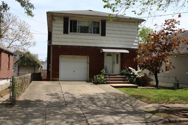 traditional-style home with brick siding, fence, driveway, and a garage