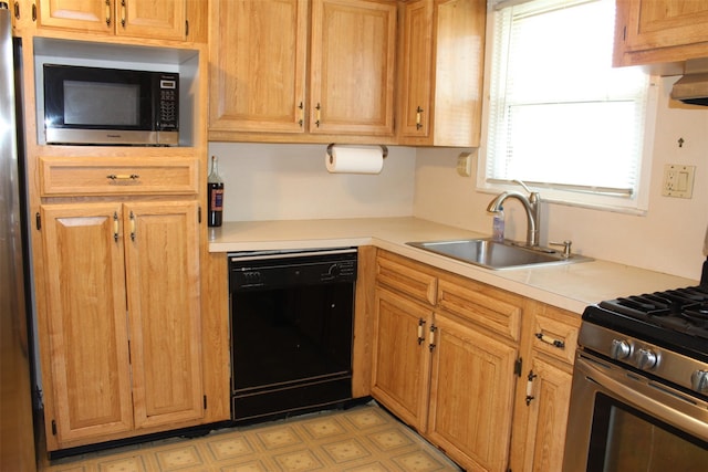 kitchen featuring light countertops, a sink, and stainless steel appliances