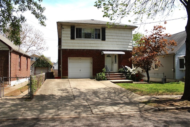 view of front of house with driveway, a gate, brick siding, fence, and an attached garage