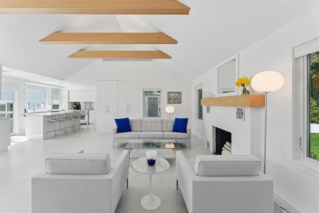 26 Basket Neck Ln, Remsenburg, NY 11960 - living room with beam ceiling, light tile patterned floors, high vaulted ceiling, baseboards, and a fireplace