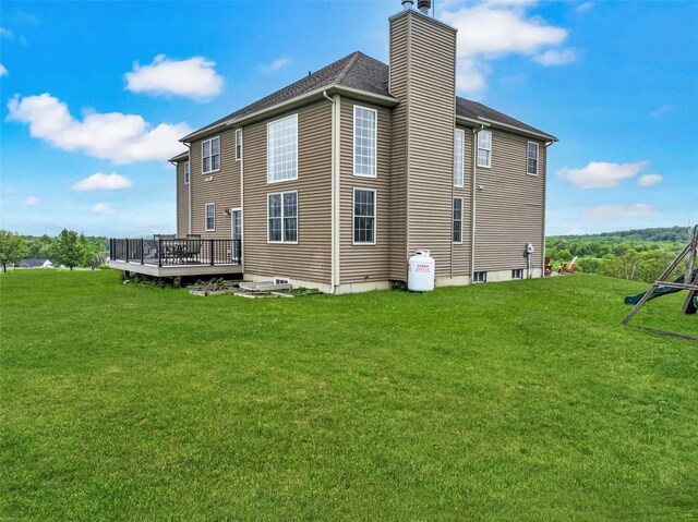 54 Fox Hill Run, Rock Tavern, NY 12575 - back of house with a deck, a chimney, and a lawn