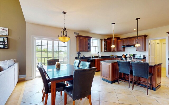 54 Fox Hill Run, Rock Tavern, NY 12575 - kitchen with dark countertops, a kitchen island, hanging light fixtures, a breakfast bar, and recessed lighting