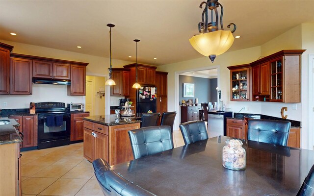 54 Fox Hill Run, Rock Tavern, NY 12575 - kitchen with black appliances, under cabinet range hood, a center island, light tile patterned floors, and decorative light fixtures