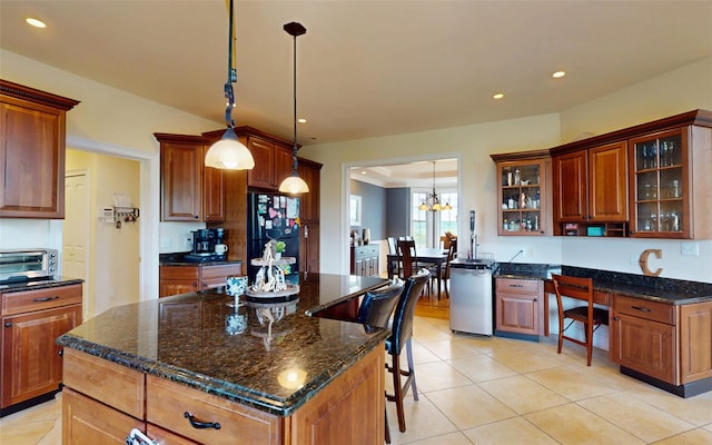 54 Fox Hill Run, Rock Tavern, NY 12575 - kitchen with light tile patterned flooring, freestanding refrigerator, glass insert cabinets, decorative light fixtures, and a kitchen breakfast bar