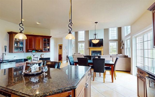 54 Fox Hill Run, Rock Tavern, NY 12575 - kitchen featuring plenty of natural light, a glass covered fireplace, glass insert cabinets, and open floor plan