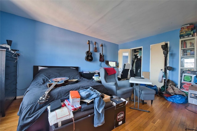 bedroom featuring hardwood / wood-style flooring and a closet